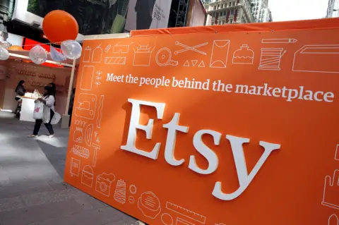 Reuters A large Etsy sign shows the company logo written in white letters on an orange background. It includes the slogan: Meet the people behind the marketplace.