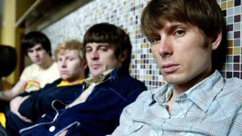 Getty Images The original line-up of Franz Ferdinand slouched against a wall and looking into the camera on a tour of Australia early in their career. 