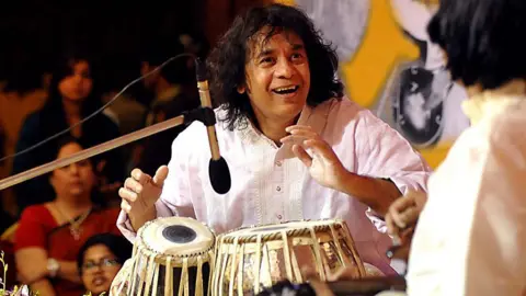 AFP Indian tabla player Ustad Zakir Hussain performs with Mandolin player U. Srinivas for the 14th Vasantotsav in Mumbai on February 27, 2014. 