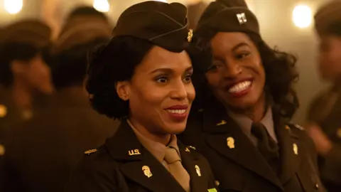 Netflix Actress Kerry Washington is seen smiling on the set of the Six Triple Eight Film flanked by another actress