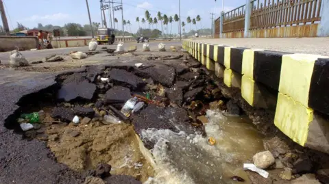 Getty Images An picture taken 28 December 2004 shows a partly-collapsed beach side street in the vincinity of Port Blair, the capital city of India's southeastern Andaman and Nicobar Islands state. Huge waves triggered by an earthquake 26 December, killed at least 4000 people on the islands leaving thousands of people missing and countless numbers homeless in India as the death toll crossed 8500 from a tsunami that slammed into unprotected coasts across Asia.