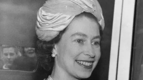 Getty Images 10th June 1964: Queen Elizabeth II is smiling and looking off camera as she is leaving Earl's Court, London, after opening a World Book Fair