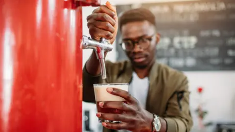 Getty Images A man pulling a pint