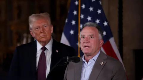 Reuters US President-elect Donald Trump (L) watches as his Middle East envoy Steve Witkoff (R) speaks at a news conference at Mar-a-Lago, Florida, US (7 January 2025)