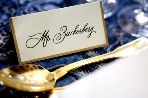 Getty Images A place setting for Meta and Facebook CEO Mark Zuckerberg is seen for a luncheon for the Inauguration of U.S. President-elect Donald Trump in Statuary Hall. His name is hand-written in a sloping script