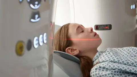 Getty Images A girl entering a CT scanning machine