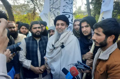 AFP  Khan Mohammad (C) who was imprisoned in America, speaks to the media as he arrived in Jalalabad on January 21, 2025, after he was released in exchange for American citizens.