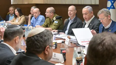 Israeli Government Press Office Prime Minister Benjamin Netanyahu (top row, 2nd right) speaks during an Israeli Security Cabinet meeting in Jerusalem (17 January 2025)