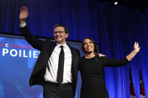 Getty Images Canada's Conservative Party newly elected leader Pierre Poilievre (L) and his wife Anaida wave to supporters during the Conservative Party Convention at the Shaw Centre, Ottawa, Canada on September 10, 2022.