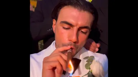 Vicky Pattison/Instagram A close up of Ramadan smoking a cigar in his white wedding suit