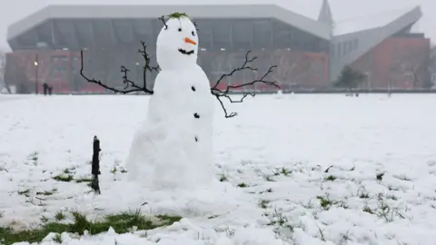 PA Media A snowman is seen outside Anfield stadium in Liverpool ahead of the Premier League clash against Manchester United.