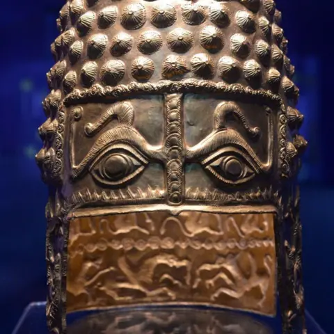 Getty Images A strikingly decorated ancient golden helmet, with eyes an snakes