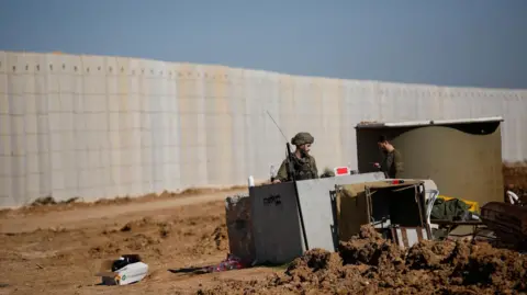 Reuters Israeli military forces stand near Israel's border with Lebanon, in northern Israel, earlier in January 