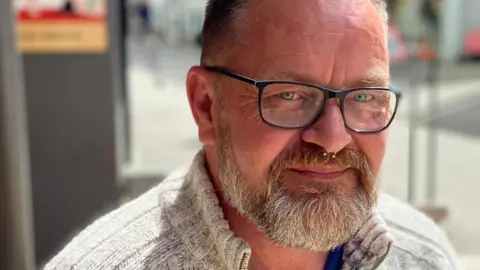 Rob Smale Close-up portrait of Rob Smale with glasses, a short beard and a nose piercing