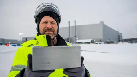 Getty Images A Northvolt worker holds up a battery outside the Northvolt plant in Skellefteå, Sweden