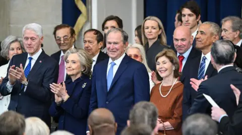 Getty Images Former US President Bill Clinton, from left, Hillary Clinton, former US secretary of state, Former US President George W. Bush, former US First Lady Laura Bush, and former US President Barack Obama arrive for the 60th presidential inauguration in Emancipation Hall of the US Capitol