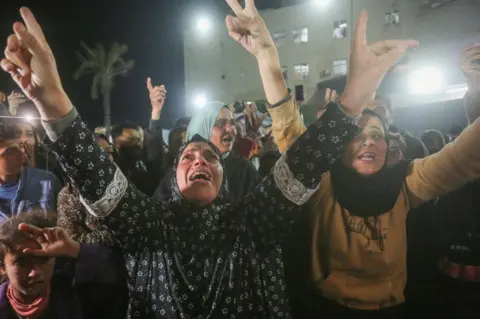 Getty Images Palestinians celebrate the announcement of ceasefire deal in Deir al-Balah, central Gaza.