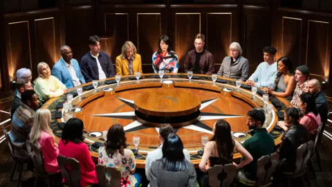 The Traitor contestants sitting around the roundtable 