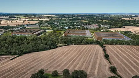 DC01UK An artist's impression depicting an aerial view, this time from further away and showing how the new buildings will look next to a large field