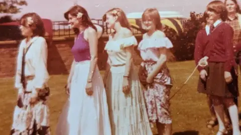 James Burnell The Nolans in late 70s floral skirt pose by a skipping rope in a photocall at their old school