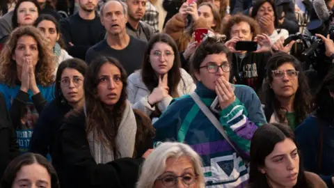 Getty Images People gathered in Tel Aviv to watch footage of the release of Israeli hostages