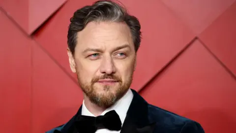 Reuters James McAvoy on the red carpet at a film event - he is wearing a suit with tie, and has a moustache and beard.