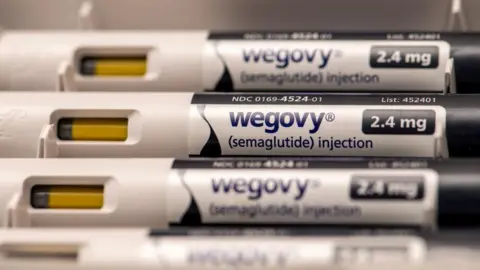 Getty Images Injectable pens lined up containing weight-loss medicine Wegovy, which is described on the label as semaglutide injection 