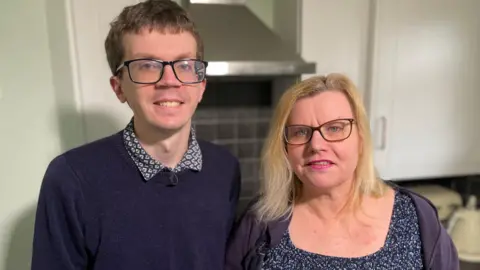 BBC Son and mother stood side-by-side in a kitchen