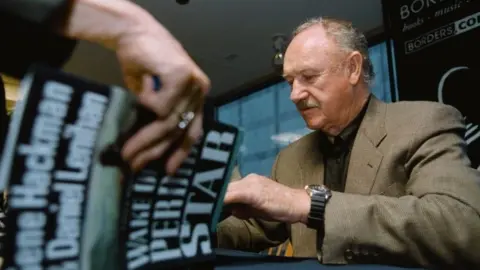 Getty Images Gene Hackman signing copies of his first novel