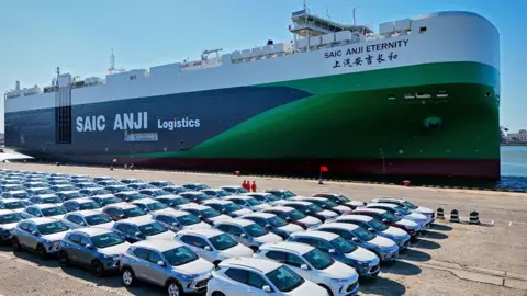 Getty Images This aerial photograph taken on May 15, 2024 shows cars for export waiting to be loaded on the 