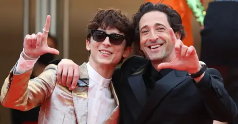 Getty Images French-Us actor Timothee Chalamet (L) US actor Adrien Brody pose as they arrive for the screening of the film 