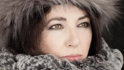 PA Media Handout photo of Kate Bush pictured in close-up wearing a hat and coat