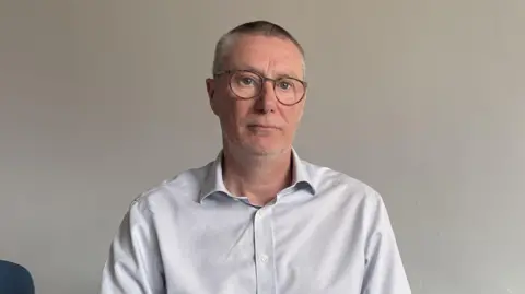 Anthony May, chief executive of Nottingham University Hospitals NUH NHS Trust, wearing a white shirt