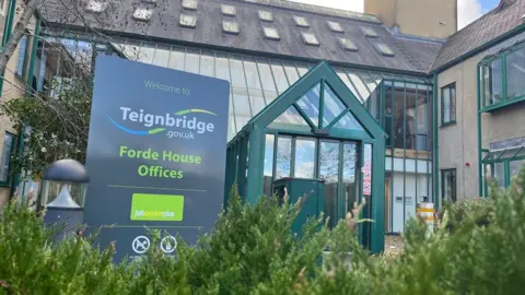 BBC The sign for Teignbridge District Council at its offices in Newton Abbot