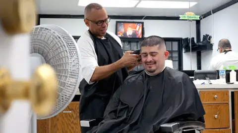 BBC/Lee Durant Kevin Smith(left) is an inmate at Estelle Supermax Penitentiary. He can be seen clippering the hair of a member of the prison staff in the prison's barber salon. 