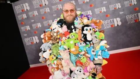 Getty Images Singer Teddy Swims covered in lots of teddy bears