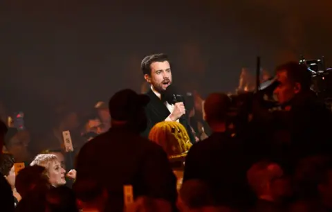 Getty Images Jack Whitehall presents the 2025 Brit Awards