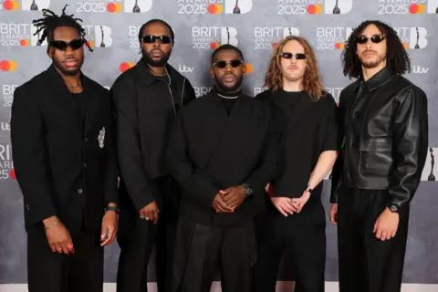 Getty Images Ezra Collective's  Ife Ogunjobi, TJ Koleoso, Femi Koleoso, Joe Armon-Jones and James Mollison appear all in black.