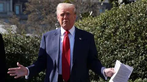 Reuters U.S. President Donald Trump speaking in front of the White House.