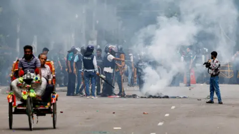 Reuters Smoke rises from a fire that was set on the street during a protest by students demanding the stepping down of Bangladeshi Prime Minister Sheikh Hasina, following quota reform protests, in Dhaka, Bangladesh, August 4, 2024.