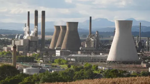 PA Media Cooling towers and industrial facilities with rolling hills in the background 