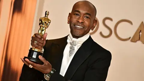 Getty Images US costume designer Paul Tazewell poses in the press room with the Oscar for Best Costume Design for 