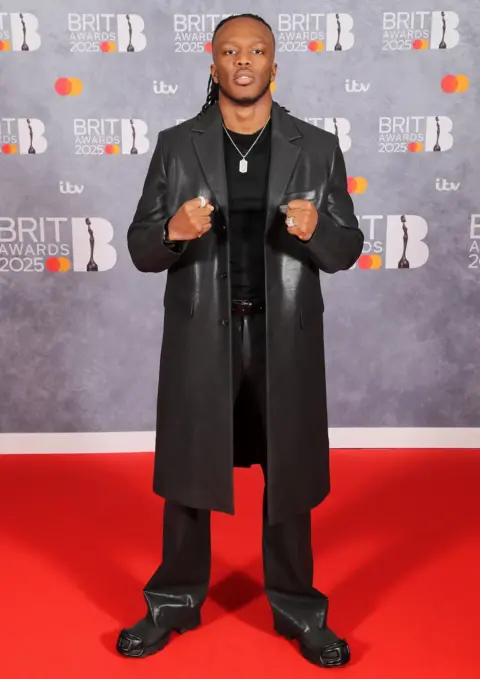 Getty Images KSI wears an all black outfit on the red carpet at the O2