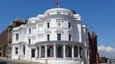 MANX SCENES The Isle of Man's parliamentary buildings. Known as the Wedding Cake building, it is a round, white three-tiered building.