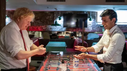 PA Media Then PM Boris Johnson and former Chancellor of the Exchequer Rishi Sunak  using hand sanitiser during a visit to the Pizza Pilgrims restaurant in east London during the Covid pandemic in 2020