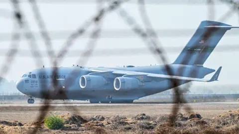 Getty Images A C-17 Globemaster III aircraft, a large military transport plane with four engines and 