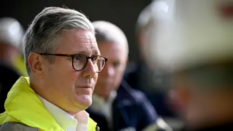 PA Media Keir Starmer in a hi-vis jacket