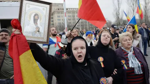 EPA A woman carried a religious icon