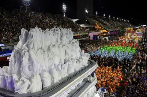 Ricardo Moraes / Reuters Revellers dressed as ghosts from Vila Isabel samba school perform against the wider backdrop of the Sambadrome