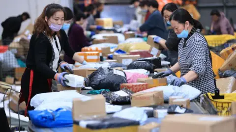 Getty Images Employees sort express parcels on an automated sorting line at a distribution center ahead of Double 11 Shopping Festival on November 4, 2024 in Lianyungang, Jiangsu Province of China. 